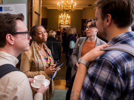 Group of people chatting at ASDC conference 2025