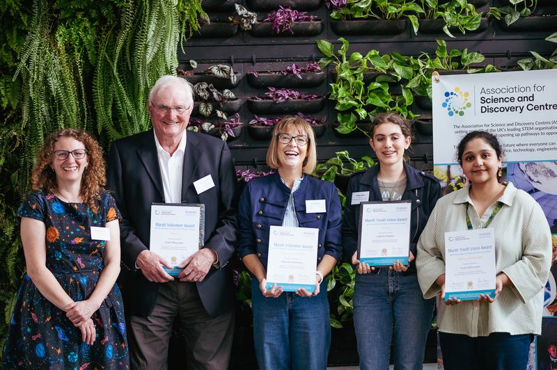 Volunteer Award winners and managers with their certificates