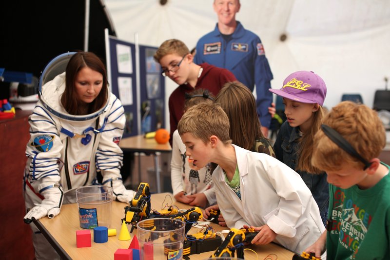 children exploring robotic arms and destination space sokul suit