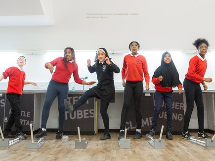 Group of school children taking part in a science experiment at Life Science Centre