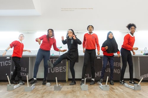 Group of school children taking part in a science experiment at Life Science Centre