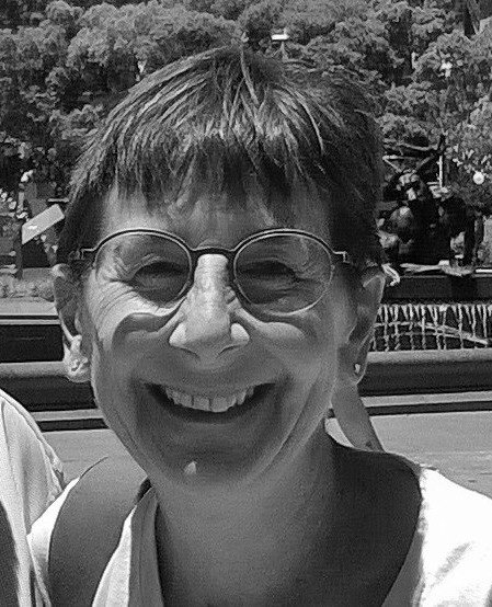 A black and white image of Melanie Quin, smiling
