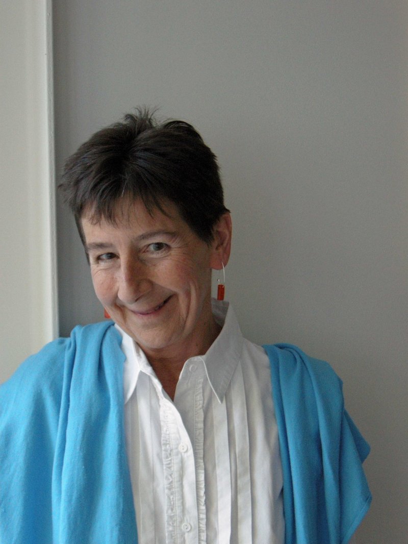 A colour photo of Melanie Quin, smiling at the camera