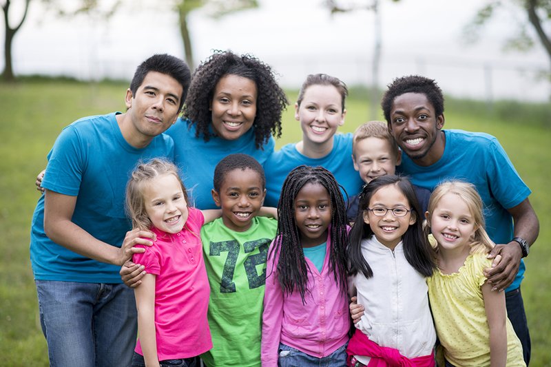 Group of adults and kids outdoors mixed ethnicity.jpg
